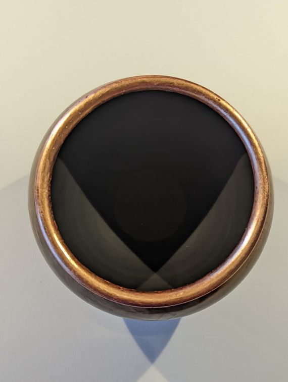 Bowl from unknown wood and filled with copper
