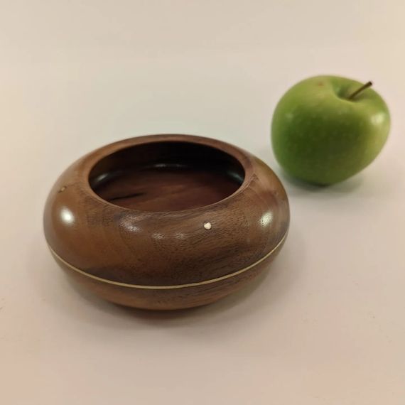 Walnut bowl with brass wire inlay