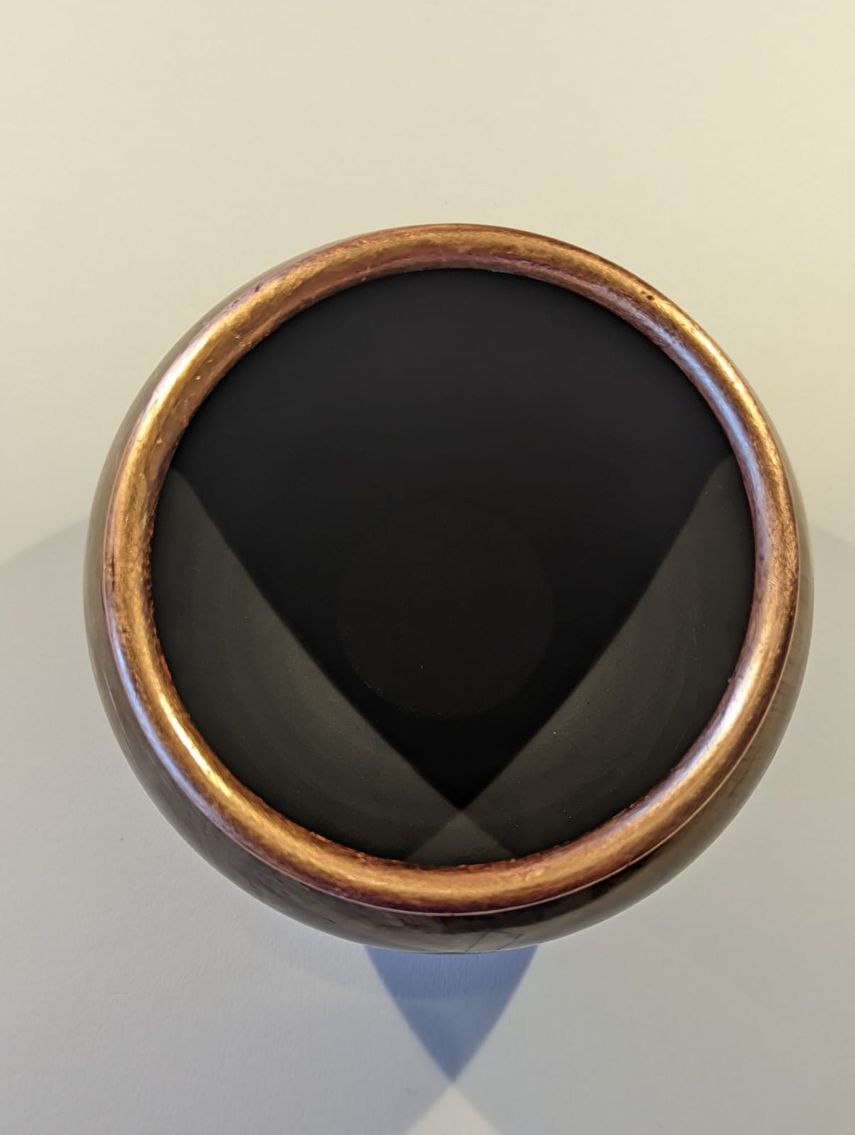 Bowl from unknown wood and filled with copper